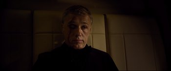 Movie still from “Spectre” (2015), directed by Sam Mendes – A person wearing a black shirt with blood on his face; Close Up shot, High angle