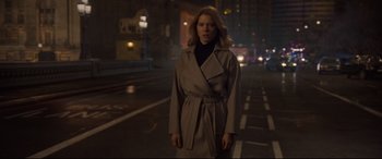 Movie still from “Spectre” (2015), directed by Sam Mendes – A woman wearing a trench coat standing on a street; Medium shot, Low angle
