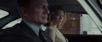 Movie still from “Spectre” (2015), directed by Sam Mendes – A man and a woman sitting in the back of a car; Close Up shot, Over the shoulder angle