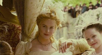 Movie still from “Elizabeth: The Golden Age” (2007), directed by Shekhar Kapur – A woman in a white dress with feathers on her head; Close Up shot, Low angle