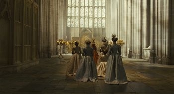 Movie still from “Elizabeth: The Golden Age” (2007), directed by Shekhar Kapur – A group of women in period dress standing in front of an altar; Wide shot, Low angle