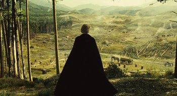 Movie still from “Elizabeth: The Golden Age” (2007), directed by Shekhar Kapur – A man in a black cape looking out over a valley; Extreme Wide shot, High angle