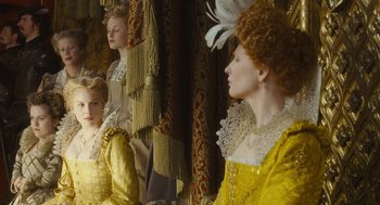 Movie still from “Elizabeth: The Golden Age” (2007), directed by Shekhar Kapur – A group of women in period costumes looking in a mirror; Medium shot, Over the shoulder angle