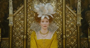 Movie still from “Elizabeth: The Golden Age” (2007), directed by Shekhar Kapur – A woman in a yellow dress with a white hat on her head; Close Up shot, Low angle