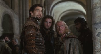Movie still from “Elizabeth: The Golden Age” (2007), directed by Shekhar Kapur – A group of men standing next to each other in a room; Medium shot, Over the shoulder angle