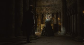 Movie still from “Elizabeth: The Golden Age” (2007), directed by Shekhar Kapur – A man and a woman standing in front of candles in a castle; Wide shot, High angle