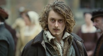 Movie still from “Elizabeth: The Golden Age” (2007), directed by Shekhar Kapur – A person with long curly hair; Close Up shot, Over the shoulder angle