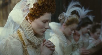 Movie still from “Elizabeth: The Golden Age” (2007), directed by Shekhar Kapur – Two women in period dress praying in a room; Close Up shot, Over the shoulder angle