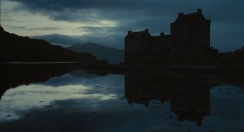 Movie still from “Elizabeth: The Golden Age” (2007), directed by Shekhar Kapur – A castle sits in the middle of a body of water at night; Extreme Wide shot, Low angle