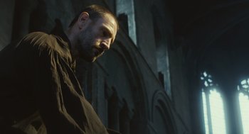 Movie still from “Elizabeth: The Golden Age” (2007), directed by Shekhar Kapur – A man with a beard is standing in front of a building; Close Up shot, Low angle