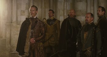 Movie still from “Elizabeth: The Golden Age” (2007), directed by Shekhar Kapur – A group of men dressed in medieval clothing; Medium shot, Over the shoulder angle