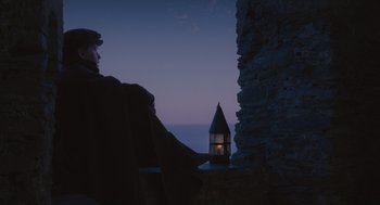 Movie still from “Elizabeth: The Golden Age” (2007), directed by Shekhar Kapur – A man sitting on a chair looking out at the sky at night; Wide shot, Low angle