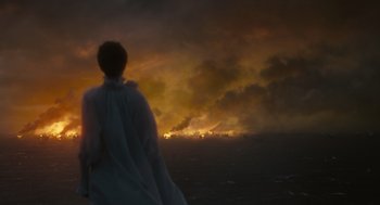 Movie still from “Elizabeth: The Golden Age” (2007), directed by Shekhar Kapur – A person standing in front of a large fire; Extreme Wide shot, Over the shoulder angle