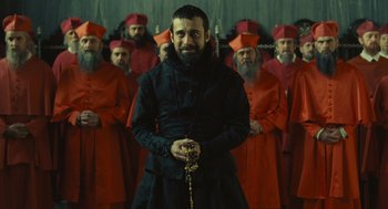 Movie still from “Elizabeth: The Golden Age” (2007), directed by Shekhar Kapur – A group of men standing next to each other in front of a wall; Medium shot, Over the shoulder angle