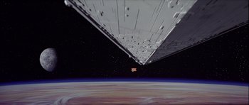 Movie still from “Star Wars: Episode IV - A New Hope” (1977), directed by George Lucas – A view of a space ship from a space station; Extreme Wide shot, Overhead angle