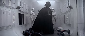 Movie still from “Star Wars: Episode IV - A New Hope” (1977), directed by George Lucas – A darth vader and two stormtroopers in a room; Wide shot, Low angle