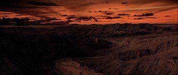 Movie still from “Star Wars: Episode IV - A New Hope” (1977), directed by George Lucas – A view of a valley at sunset with mountains in the background; Extreme Wide shot, High angle