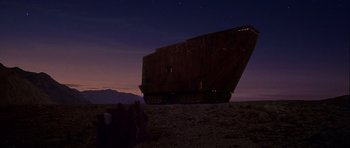 Movie still from “Star Wars: Episode IV - A New Hope” (1977), directed by George Lucas – A large object sitting on top of a sandy beach at night; Extreme Wide shot, Low angle