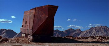 Movie still from “Star Wars: Episode IV - A New Hope” (1977), directed by George Lucas – An old rusty boat sitting on top of a sandy beach; Extreme Wide shot, Low angle