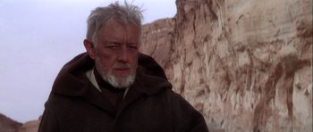 Movie still from “Star Wars: Episode IV - A New Hope” (1977), directed by George Lucas – An older man with a beard and a white beard; Close Up shot, Over the shoulder angle