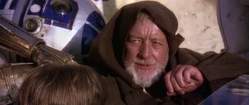 Movie still from “Star Wars: Episode IV - A New Hope” (1977), directed by George Lucas – An older man with a beard and a hooded jacket; Close Up shot, Over the shoulder angle