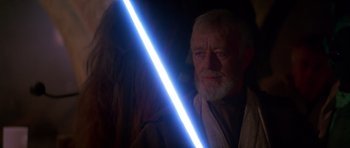 Movie still from “Star Wars: Episode IV - A New Hope” (1977), directed by George Lucas – An old man with a long white beard holding a light saber; Close Up shot, Over the shoulder angle