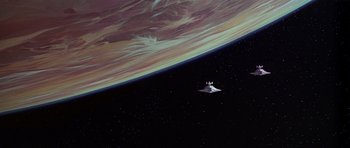 Movie still from “Star Wars: Episode IV - A New Hope” (1977), directed by George Lucas – An image of a space ship flying in the sky; Extreme Wide shot, Overhead angle