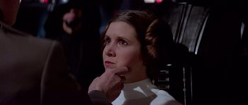 Movie still from “Star Wars: Episode IV - A New Hope” (1977), directed by George Lucas – A woman in a white shirt is looking at a man; Close Up shot, Over the shoulder angle