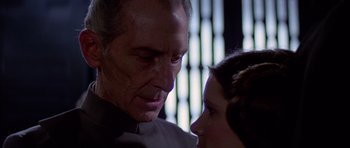 Movie still from “Star Wars: Episode IV - A New Hope” (1977), directed by George Lucas – An older man and a young woman face to face; Close Up shot, Over the shoulder angle