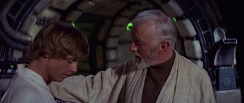 Movie still from “Star Wars: Episode IV - A New Hope” (1977), directed by George Lucas – An older man and a young boy in a room; Close Up shot, Over the shoulder angle