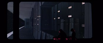 Movie still from “Star Wars: Episode IV - A New Hope” (1977), directed by George Lucas – Two people are sitting in a dark room; Extreme Wide shot, Low angle