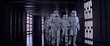 Movie still from “Star Wars: Episode IV - A New Hope” (1977), directed by George Lucas – A group of star wars stormtroopers in a hallway; Wide shot, Low angle