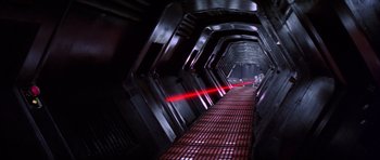 Movie still from “Star Wars: Episode IV - A New Hope” (1977), directed by George Lucas – A red light is shining on a dark hallway; Extreme Wide shot, High angle