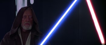 Movie still from “Star Wars: Episode IV - A New Hope” (1977), directed by George Lucas – A person with a lightsaber standing in the dark; Close Up shot, Low angle