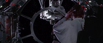 Movie still from “Star Wars: Episode IV - A New Hope” (1977), directed by George Lucas – A person standing in front of a space station; Close Up shot, Overhead angle
