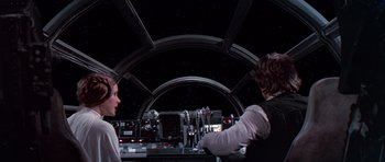 Movie still from “Star Wars: Episode IV - A New Hope” (1977), directed by George Lucas – Two people sitting at a table in a space station; Medium shot, Low angle