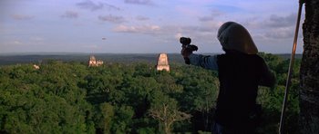 Movie still from “Star Wars: Episode IV - A New Hope” (1977), directed by George Lucas – A man holding a camera in front of an ancient mayan temple; Extreme Wide shot, Low angle