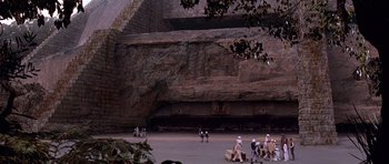 Movie still from “Star Wars: Episode IV - A New Hope” (1977), directed by George Lucas – A group of people standing in front of a rock wall; Extreme Wide shot, High angle