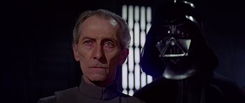 Movie still from “Star Wars: Episode IV - A New Hope” (1977), directed by George Lucas – An older man with a darth vader mask on; Close Up shot, Over the shoulder angle