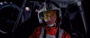 Movie still from “Star Wars: Episode IV - A New Hope” (1977), directed by George Lucas – A young man in a helmet in an airplane cockpit; Close Up shot, Low angle