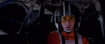 Movie still from “Star Wars: Episode IV - A New Hope” (1977), directed by George Lucas – A man in a helmet in a space ship; Close Up shot, Overhead angle
