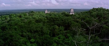 Movie still from “Star Wars: Episode IV - A New Hope” (1977), directed by George Lucas – A view of a forest with two towers in the middle of it; Extreme Wide shot, High angle