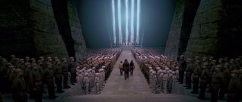 Movie still from “Star Wars: Episode IV - A New Hope” (1977), directed by George Lucas – A group of people standing in front of an army; Extreme Wide shot, High angle