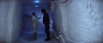Movie still from “Star Wars: Episode V - The Empire Strikes Back” (1980), directed by Irvin Kershner – Two people standing next to each other in a room; Wide shot, Low angle
