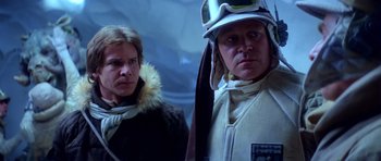 Movie still from “Star Wars: Episode V - The Empire Strikes Back” (1980), directed by Irvin Kershner – Two people standing next to each other in front of a wall; Close Up shot, Low angle