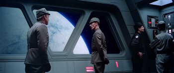 Movie still from “Star Wars: Episode V - The Empire Strikes Back” (1980), directed by Irvin Kershner – A man in a uniform standing in front of a space ship; Medium shot, Over the shoulder angle