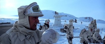Movie still from “Star Wars: Episode V - The Empire Strikes Back” (1980), directed by Irvin Kershner – A group of people standing on top of a snow covered slope; Medium shot, Low angle