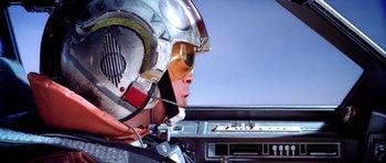 Movie still from “Star Wars: Episode V - The Empire Strikes Back” (1980), directed by Irvin Kershner – A person wearing a pilot's helmet in the cockpit of an airplane; Close Up shot, Low angle