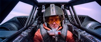Movie still from “Star Wars: Episode V - The Empire Strikes Back” (1980), directed by Irvin Kershner – A man in a fighter jet cockpit wearing a helmet; Close Up shot, Low angle