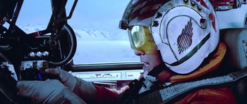 Movie still from “Star Wars: Episode V - The Empire Strikes Back” (1980), directed by Irvin Kershner – A person wearing a helmet in a cockpit of an airplane; Close Up shot, Low angle